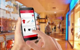 Smart phone online shopping in man hand during Christmas