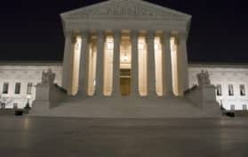 US Supreme Court building in Washington, D C at night