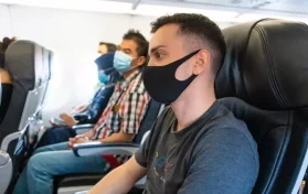 people wearing masks on plane