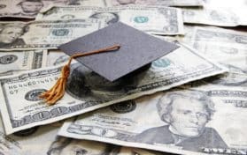 Graduation cap on a pile of money